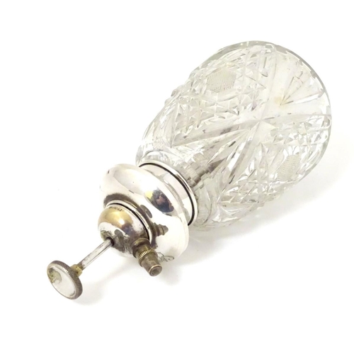 167 - A cut glass scent / perfume bottle with Sterling silver mount and atomiser top. 5 1/2'' high