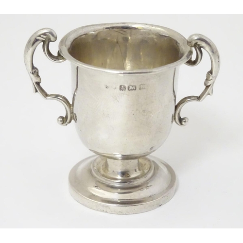 169 - A miniature silver two handled trophy cup hallmarked Birmingham 1929 2'' high (24g)