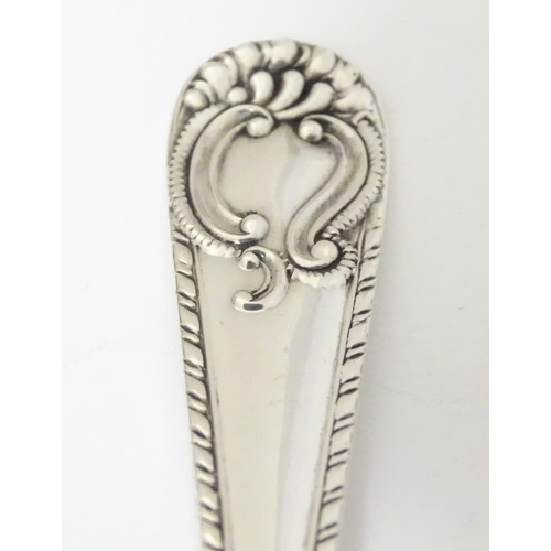 171 - An Edwardian silver serving spoon, having engraved decoration to fluted bowl hallmarked London 1904 ... 