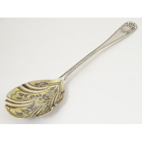 171 - An Edwardian silver serving spoon, having engraved decoration to fluted bowl hallmarked London 1904 ... 