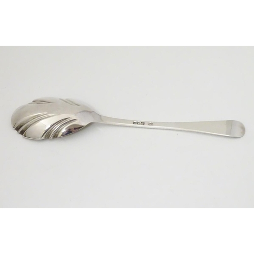 171 - An Edwardian silver serving spoon, having engraved decoration to fluted bowl hallmarked London 1904 ... 