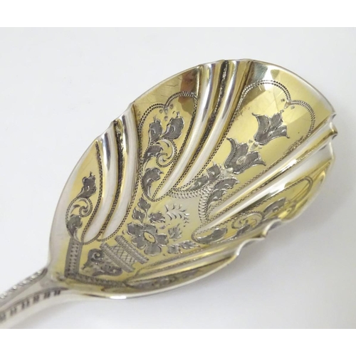 171 - An Edwardian silver serving spoon, having engraved decoration to fluted bowl hallmarked London 1904 ... 