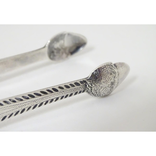 175 - Geo III silver sugar tongs with bright cut decoration and acorn formed grips. With incuse duty mark.... 