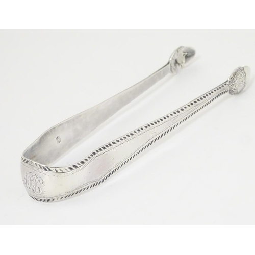 175 - Geo III silver sugar tongs with bright cut decoration and acorn formed grips. With incuse duty mark.... 