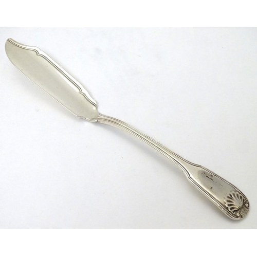 179 - A Victorian silver fiddle shell and thread pattern butter knife hallmarked London 1841. 8'' long (56... 