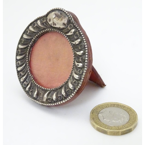 186 - A miniature photograph frame with silver surround. Hallmarked Birmingham 1901 2'' high