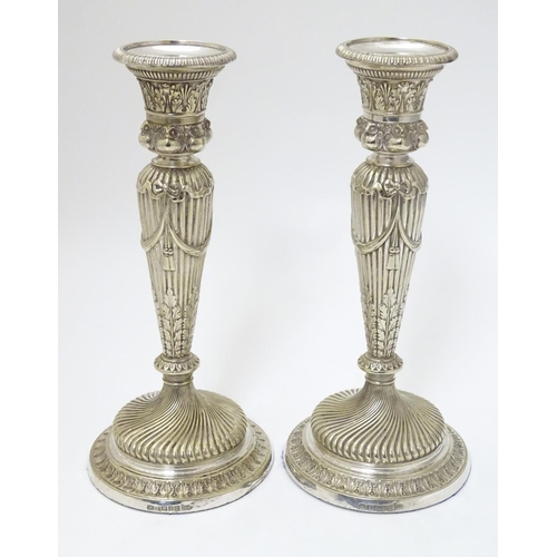 190 - A pair of silver plate candle sticks with columns decorated with swag decorated with band of owl dec... 