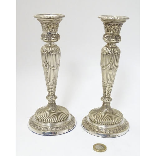 190 - A pair of silver plate candle sticks with columns decorated with swag decorated with band of owl dec... 