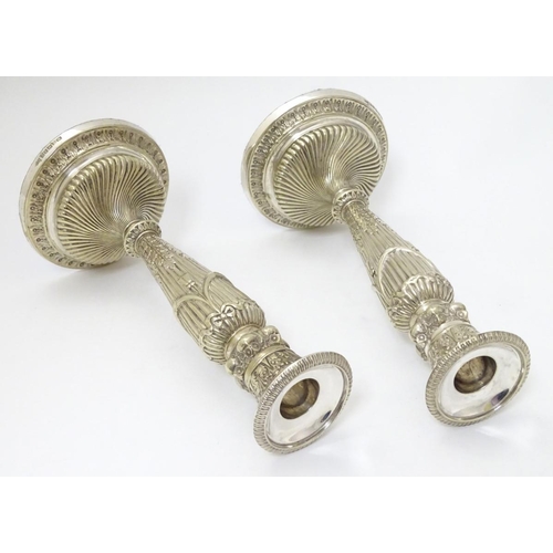 190 - A pair of silver plate candle sticks with columns decorated with swag decorated with band of owl dec... 