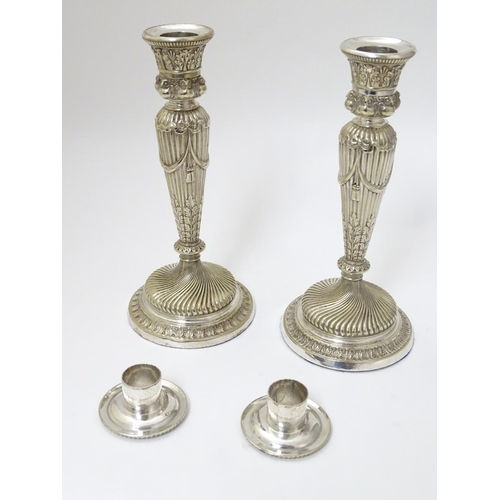 190 - A pair of silver plate candle sticks with columns decorated with swag decorated with band of owl dec... 