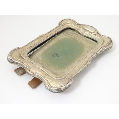 194 - An Art Nouveau silver photograph frame with hammered decoration. Hallmarked Birmingham 1903 maker He... 