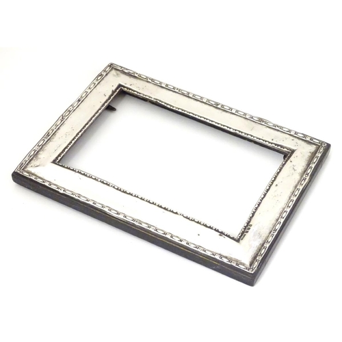 196 - A silver mounted photo frame hallmarked Birmingham 1911 maker Green & Cadbury Ltd. 7 1/2'' x 5 1/4''... 