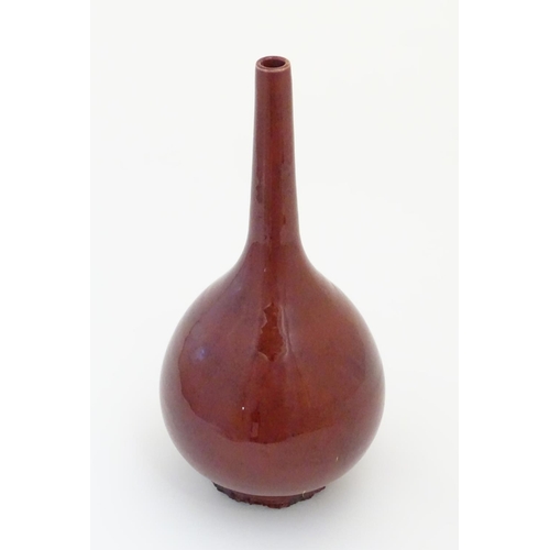 2 - A Chinese pear-shaped vase with a slender, elongated neck with a sang de boeuf glaze. Approx. 17 1/2... 