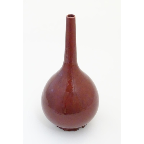 2 - A Chinese pear-shaped vase with a slender, elongated neck with a sang de boeuf glaze. Approx. 17 1/2... 