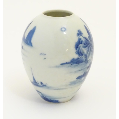 20 - A small Chinese blue and white vase, decorated with a landscape to include mountains, bridges, boats... 