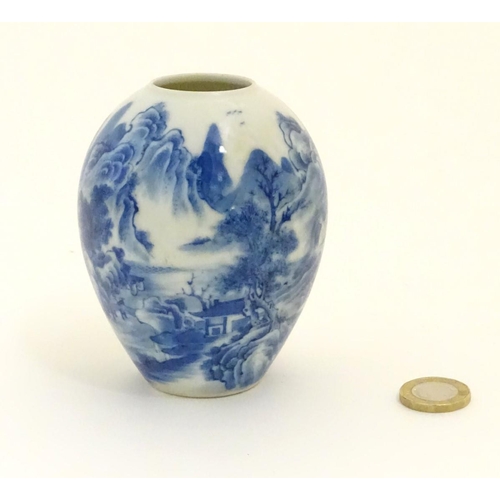 20 - A small Chinese blue and white vase, decorated with a landscape to include mountains, bridges, boats... 