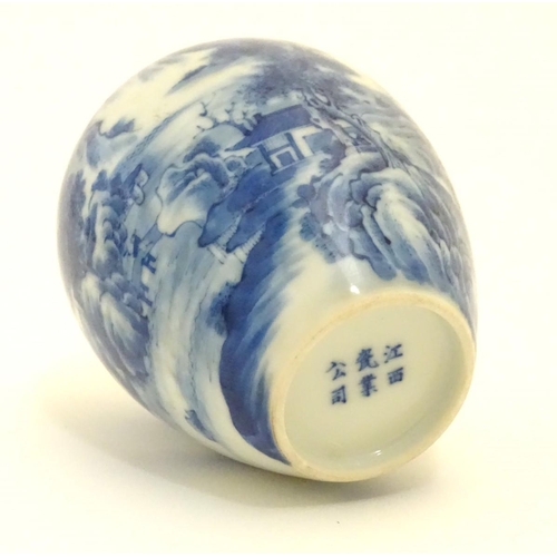 20 - A small Chinese blue and white vase, decorated with a landscape to include mountains, bridges, boats... 