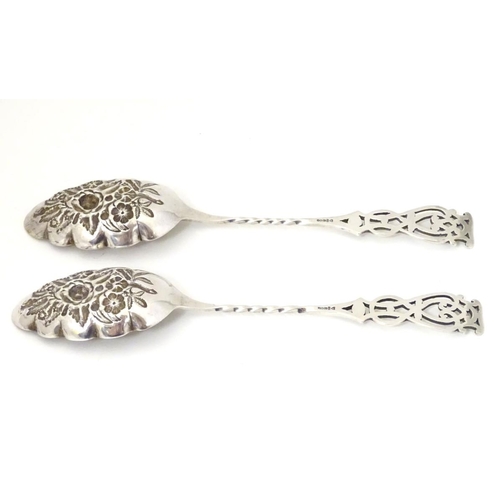 205A - A pair of silver plate berry spoons with open work decoration to handles. 8 1/4'' long