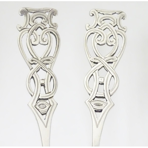 205A - A pair of silver plate berry spoons with open work decoration to handles. 8 1/4'' long