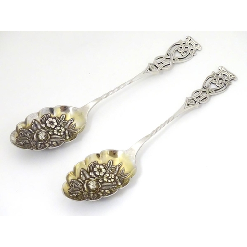 205A - A pair of silver plate berry spoons with open work decoration to handles. 8 1/4'' long