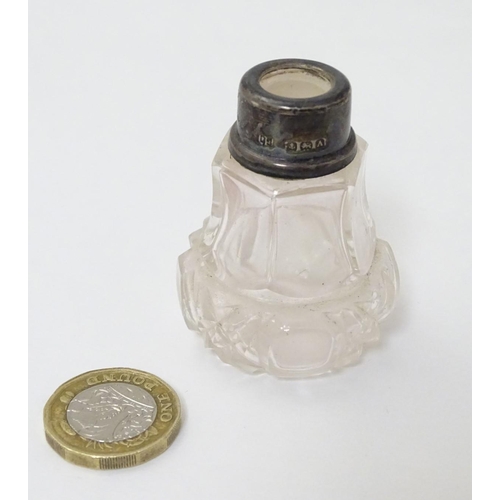 218 - A cut glass scent bottle with silver collar hallmarked Birmingham 1925. 2'' high overall.