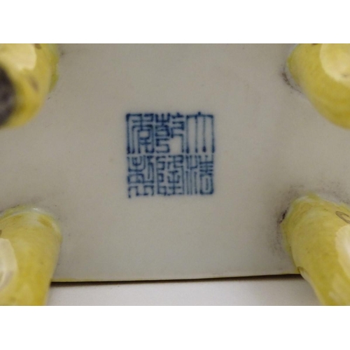 22 - A Chinese rectangular censer with a yellow ground, raised on 4 paw footed legs, with twin upright ha... 