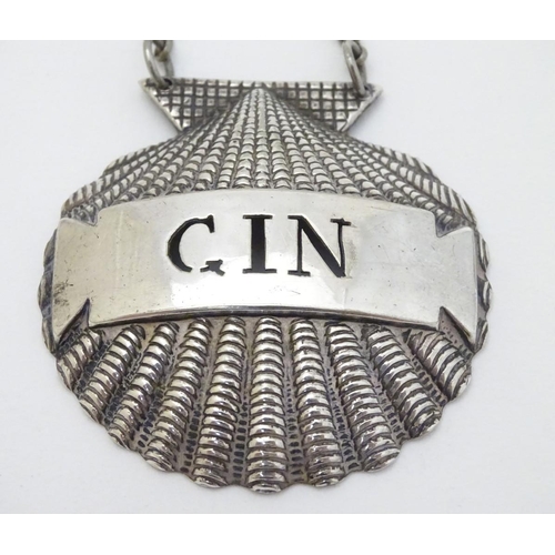 225 - Two silver plate decanter labels / bottle tags of scallop shell form 'Gin' and 'Port. ' 2'' wide