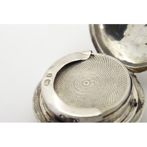 229 - A silver sovereign case with engraved decoration. 1 1/4'' diameter