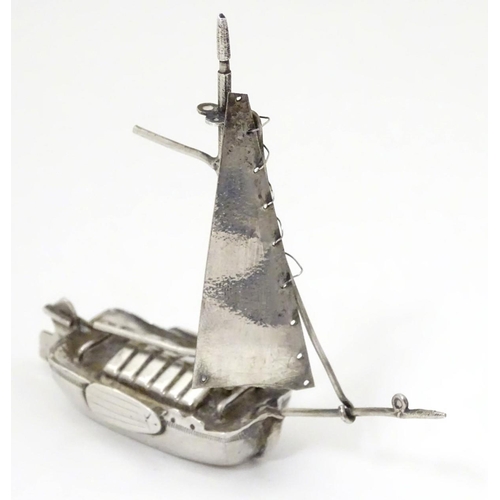 235 - A silver miniature model of a boat. Hallmarked Chester 1901 with import mark. Maker Samuel Boyce Lan... 