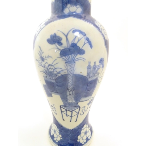 25 - A Chinese blue and white baluster vase decorated with prunus flowers, the central decoration display... 