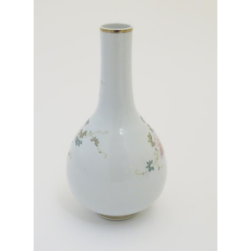 28 - A Chinese globular vase with an elongated neck decorated with peacocks and flowers in a landscape, w... 