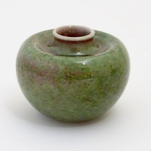 29 - A small Chinese brush washer of circular form in a mottled green and pink glaze. Character marks und... 