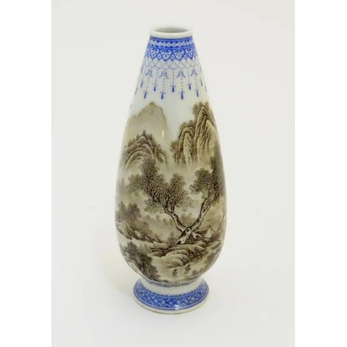 30 - A 20thC Chinese bud vase with mountainous landscape decoration with trees, figures, boats etc. and w... 