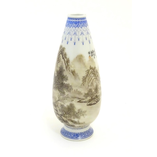 30 - A 20thC Chinese bud vase with mountainous landscape decoration with trees, figures, boats etc. and w... 