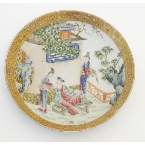 32 - A small Chinese famille rose plate decorated with figures on a terrace within a landscape with a pag... 