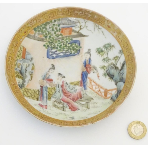 32 - A small Chinese famille rose plate decorated with figures on a terrace within a landscape with a pag... 