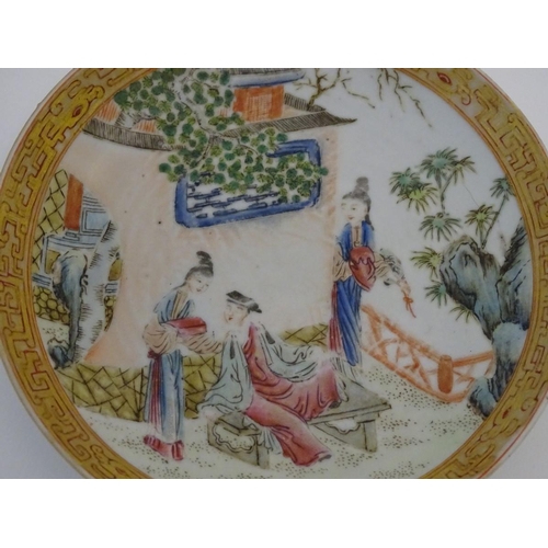 32 - A small Chinese famille rose plate decorated with figures on a terrace within a landscape with a pag... 