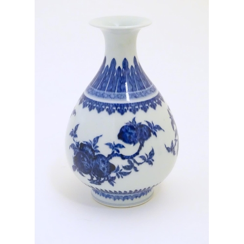 41 - A Chinese blue and white pear shaped / yuhuchunping vase with a flared rim, decorated with fruiting ... 