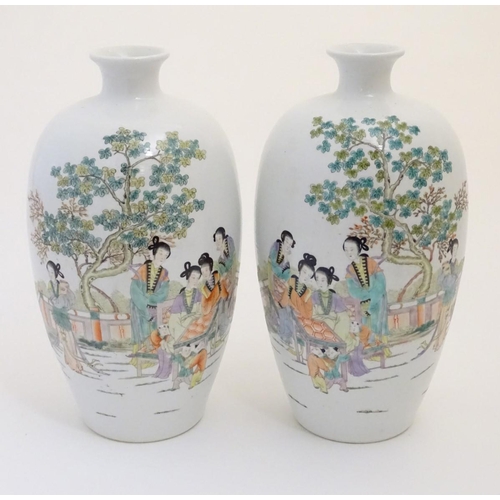 43 - A pair of 20thC Chinese vases decorated with figures on a terrace in a landscape. Approx. 15'' high ... 