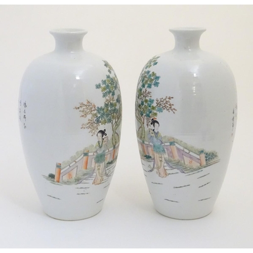 43 - A pair of 20thC Chinese vases decorated with figures on a terrace in a landscape. Approx. 15'' high ... 