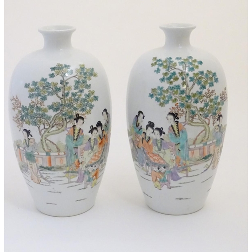 43 - A pair of 20thC Chinese vases decorated with figures on a terrace in a landscape. Approx. 15'' high ... 