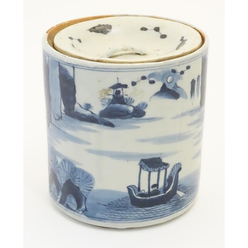 46 - A 19thC Chinese blue and white lidded pot / biscuit barrel decorated with Chinese script and a water... 