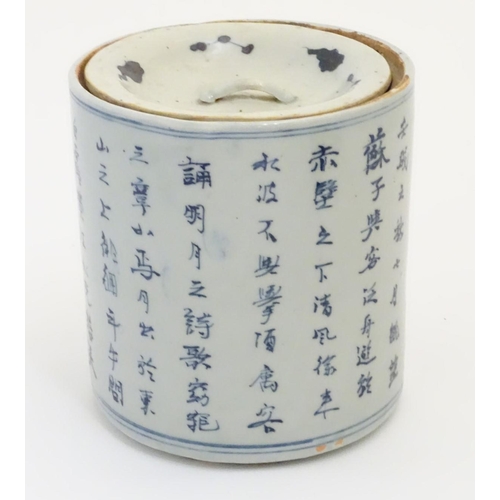 46 - A 19thC Chinese blue and white lidded pot / biscuit barrel decorated with Chinese script and a water... 