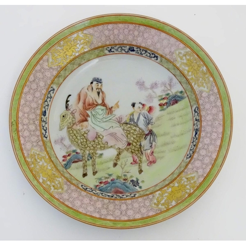 51 - A Chinese famille rose plate decorated with Shou-Lao, the God of Longevity, riding a spotted deer in... 