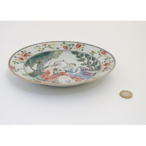 54 - A Chinese export famille rose plate, depicting a mythological scene of Apollo playing his lyre, seat... 