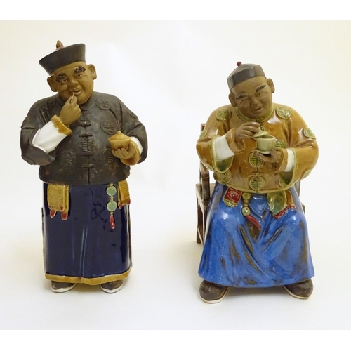 57 - Two ceramic figures of Chinese men in traditional dress drinking tea, one seated, the other standing... 