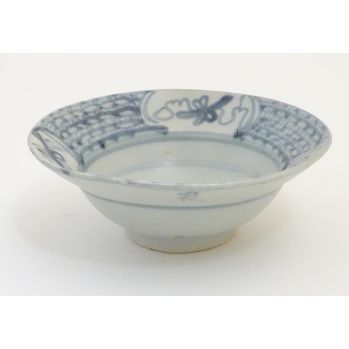 60 - An 18thC Chinese blue and white bowl, with hand painted decoration, the border decorated with scroll... 