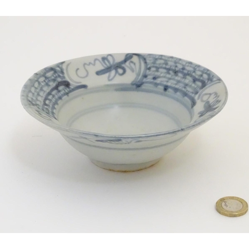 60 - An 18thC Chinese blue and white bowl, with hand painted decoration, the border decorated with scroll... 