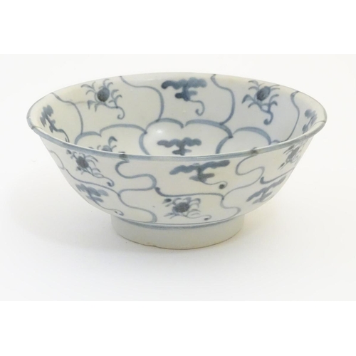 61 - An 18thC Chinese blue and white bowl, with hand painted floral panels and spiral decoration to the c... 