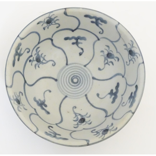 61 - An 18thC Chinese blue and white bowl, with hand painted floral panels and spiral decoration to the c... 